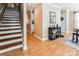 Welcoming entryway featuring a staircase, console table, and hardwood flooring at 2040 Brantley Creek Dr, Kannapolis, NC 28083