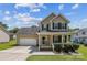 Charming two-story home with a welcoming front porch, attached garage, and well-manicured lawn under a sunny sky at 2040 Brantley Creek Dr, Kannapolis, NC 28083