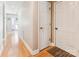 Inviting hallway with light-colored walls and hardwood floors leading to a brightly lit entryway at 2040 Brantley Creek Dr, Kannapolis, NC 28083