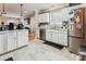 Well-lit kitchen featuring white cabinets, marble countertops, stainless steel appliances, and ample storage space at 2040 Brantley Creek Dr, Kannapolis, NC 28083