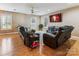 Cozy living room with hardwood floors, comfortable seating, and a mounted flat-screen television at 2040 Brantley Creek Dr, Kannapolis, NC 28083