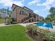 A brick home with a screened-in porch over looking a crystal clear pool, perfect for relaxing at 217 Turtleback Rdg, Weddington, NC 28104