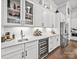Stylish bar area featuring a wine cooler, custom cabinets, and a sink for entertaining at 217 Turtleback Rdg, Weddington, NC 28104