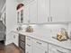Elegant bar area with custom cabinetry, a wine cooler, and quartz countertops at 217 Turtleback Rdg, Weddington, NC 28104