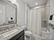 Bathroom with granite vanity, large mirror, and tiled shower with tub at 217 Turtleback Rdg, Weddington, NC 28104