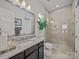 Bright bathroom featuring a glass-enclosed shower, granite vanity and a large, decorative mirror at 217 Turtleback Rdg, Weddington, NC 28104