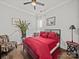 Bedroom with dark hardwood floors, bright red bedding, and a stylish sitting area at 217 Turtleback Rdg, Weddington, NC 28104