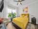 A sunlit bedroom features a comfortable bed, stylish decor, and a relaxing seating area at 217 Turtleback Rdg, Weddington, NC 28104