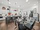 Elegant dining room with a large glass table and contemporary chairs with modern pendant lights at 217 Turtleback Rdg, Weddington, NC 28104