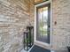 Close up of the front door of a brick home accented with black lanterns and lovely greenery at 217 Turtleback Rdg, Weddington, NC 28104