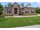 Beautiful brick home featuring a stone facade entrance, manicured lawn and mature landscaping at 217 Turtleback Rdg, Weddington, NC 28104