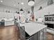 Spacious modern kitchen with an island, bar seating, stainless steel appliances, and pendant lighting at 217 Turtleback Rdg, Weddington, NC 28104