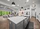 Modern kitchen boasts a central island, stainless steel appliances, and dark wood flooring at 217 Turtleback Rdg, Weddington, NC 28104
