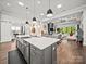 Open kitchen with island, stainless steel appliances, and seamless access to the living area at 217 Turtleback Rdg, Weddington, NC 28104