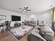 Open living room with a large rug, leather furniture, and a flat screen television at 217 Turtleback Rdg, Weddington, NC 28104