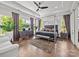 A stylish main bedroom is spacious and bright with a four-poster bed and sleek furniture at 217 Turtleback Rdg, Weddington, NC 28104