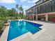 Inviting backyard pool features a tanning ledge, outdoor dining and plenty of shade from mature trees at 217 Turtleback Rdg, Weddington, NC 28104
