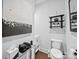 Bright half bath features a floating vanity, hardwood floors, and stylish artwork for an elevated feel at 217 Turtleback Rdg, Weddington, NC 28104