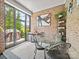 This sunny sunroom features exposed brick, lots of plants, and an outdoor view at 217 Turtleback Rdg, Weddington, NC 28104