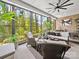 A beautiful sunroom with brick walls and large windows offers stunning views and comfortable seating at 217 Turtleback Rdg, Weddington, NC 28104