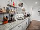 Modern wet bar with granite countertops, stainless steel sink, and ample liquor storage at 217 Turtleback Rdg, Weddington, NC 28104