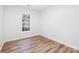 Bright, airy bedroom with wood-look floors and a large window for natural light at 3100 Hickory Grove Dr, Monroe, NC 28110