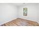 Bright bedroom with a window providing natural light, complemented by modern, wood-look flooring at 3100 Hickory Grove Dr, Monroe, NC 28110
