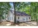 Well-maintained home exterior with siding, a backyard patio and mature trees at 3100 Hickory Grove Dr, Monroe, NC 28110