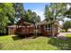 A beautiful backyard featuring a large deck with a covered area, grass and many trees for shade at 324 Swamp Fox Dr, Fort Mill, SC 29715