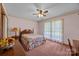 Bright bedroom featuring a bed, side table, lamp, and window at 324 Swamp Fox Dr, Fort Mill, SC 29715