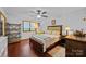 Cozy bedroom featuring wood floors, bed, nightstand, and window at 324 Swamp Fox Dr, Fort Mill, SC 29715