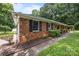 Charming single-story brick home featuring well-manicured garden beds and a walkway leading to the entrance at 324 Swamp Fox Dr, Fort Mill, SC 29715