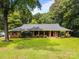 Charming one-story brick home with a cozy front porch and lush green lawn at 324 Swamp Fox Dr, Fort Mill, SC 29715