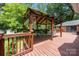 Charming gazebo on the backyard deck with seating, perfect for relaxation at 324 Swamp Fox Dr, Fort Mill, SC 29715