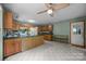 Spacious kitchen with wood cabinets, green counters, a ceiling fan, and white appliances at 324 Swamp Fox Dr, Fort Mill, SC 29715