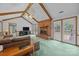 Cozy living room with a brick fireplace, high ceilings, exposed beams, and access to the deck at 324 Swamp Fox Dr, Fort Mill, SC 29715