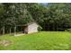 A wooden outbuilding with a lean-to is set in a lush, private, wooded yard at 324 Swamp Fox Dr, Fort Mill, SC 29715