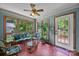 Cozy sunroom with brick floors, lots of light, and comfortable seating at 324 Swamp Fox Dr, Fort Mill, SC 29715