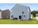 This backyard features a grill, patio, basketball hoop, and manicured lawn at 3734 Stanley Creek Dr, Mount Holly, NC 28120