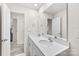 Well-lit bathroom with double sink vanity and tile flooring at 3734 Stanley Creek Dr, Mount Holly, NC 28120