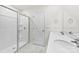 Modern bathroom featuring a double vanity, hexagon tiled floor, and glass-enclosed shower at 3734 Stanley Creek Dr, Mount Holly, NC 28120