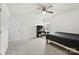 Neutral bedroom featuring a ceiling fan, neutral carpet, and an adjacent desk area at 3734 Stanley Creek Dr, Mount Holly, NC 28120