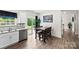 Dining area with wood floors, a sliding glass door to the backyard, and a wooden dining table at 3734 Stanley Creek Dr, Mount Holly, NC 28120