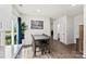 Open dining area with wood floors, sliding glass doors to the backyard, and modern decor at 3734 Stanley Creek Dr, Mount Holly, NC 28120
