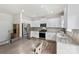Bright kitchen boasts stainless steel appliances, white cabinetry, granite countertops, and a wooden dining table at 3734 Stanley Creek Dr, Mount Holly, NC 28120