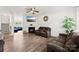 Inviting living room featuring a fireplace, ceiling fan, hardwood floors, and comfortable seating at 3734 Stanley Creek Dr, Mount Holly, NC 28120