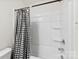 Shower and bath combination with black and white checkered curtain at 3734 Stanley Creek Dr, Mount Holly, NC 28120