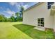 View of the back exterior, a sliding glass door, and large grassy yard, creating a private retreat at 3855 Tersk Dr, Midland, NC 28107