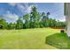 Expansive green backyard with lush grass and partial fence, perfect for outdoor activities and relaxation at 3855 Tersk Dr, Midland, NC 28107