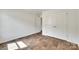 Light-filled bedroom with wood-look floors, double door closet, and an entrance to an adjacent room at 3855 Tersk Dr, Midland, NC 28107